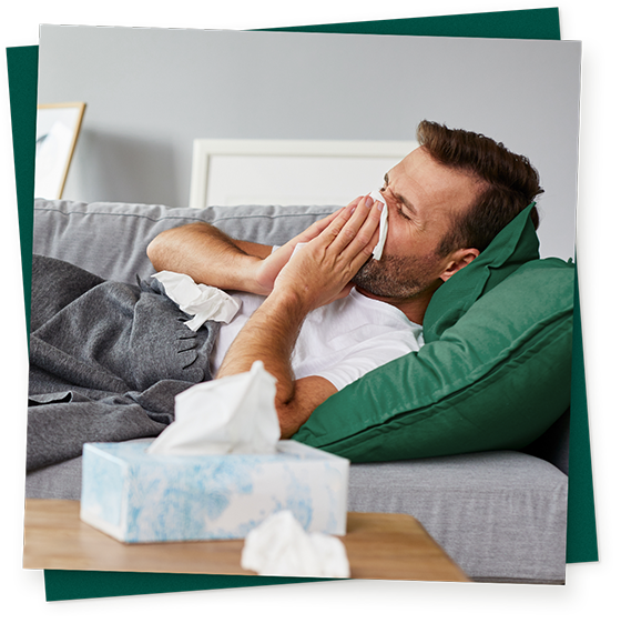 Mann mit Grippe im Bett